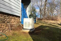 Home generator installed beside a house by PE Home Generators.