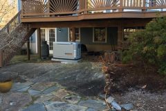 Generac home generator installed under a deck by PE Home Generators.