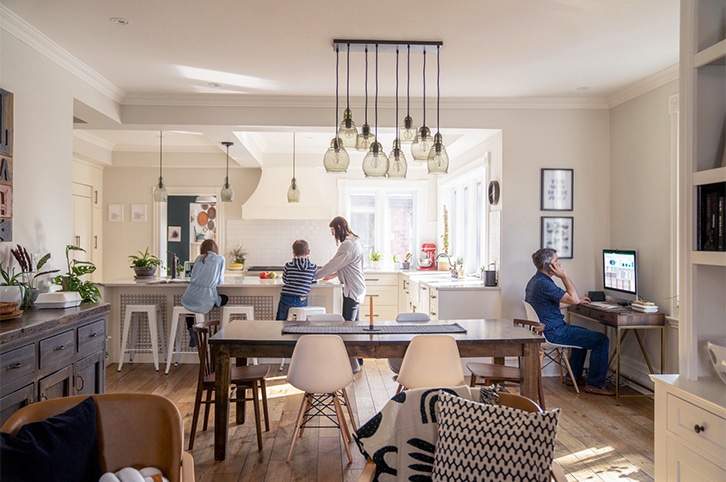 Family standing in a bright, open energy-efficient home.