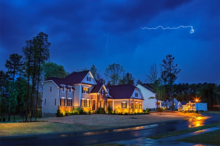 Connecticut home with a strike of lighting in the background.